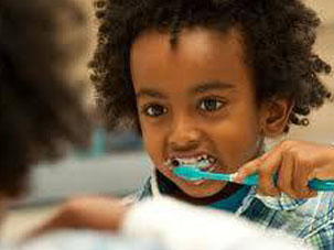 Giving children a free dental check-up. Dentist Marbella Dr Hotz.